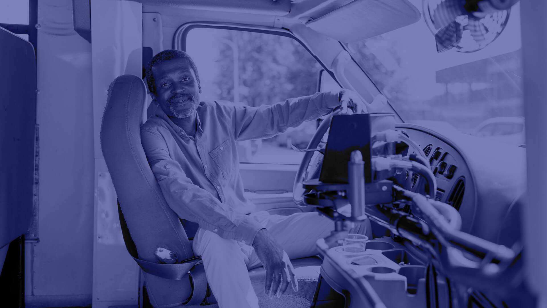 A male energy worker sitting in a work vehicle